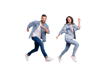 Full length body size photo of rejoicing couple of friends running towards shopping mall for sales while isolated with blue background