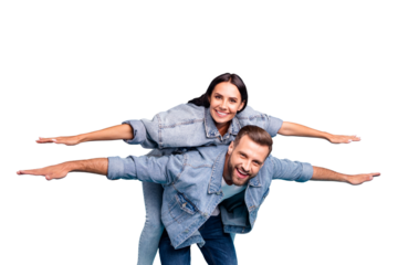 Portrait of charming people raising their hands laughing wearing denim jeans jackets isolated over blue background