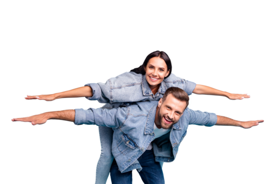 Portrait of charming people raising their hands laughing wearing denim jeans jackets isolated over blue background