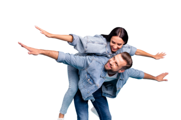 Portrait of attractive guy carrying his woman looking wearing denim jeans jeackets isolated over blue background