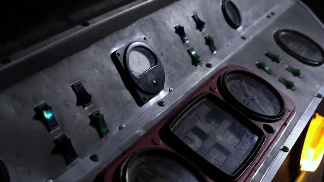 Close-up of an old control panel in the cab of a train or subway. A dark room with a train dashboard.