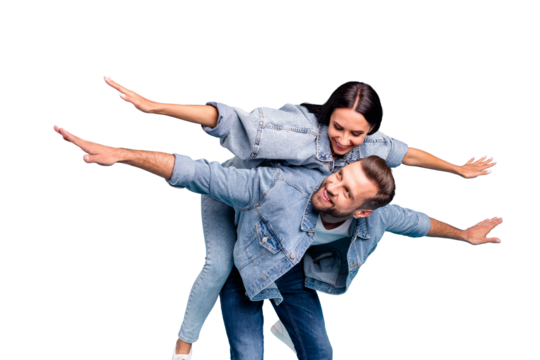 Portrait of attractive guy carrying his woman looking wearing denim jeans jeackets isolated over blue background