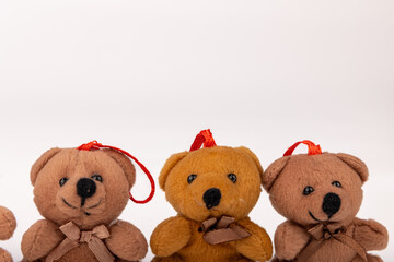 Teddy Bears in Christmas Attire Sitting Together on White