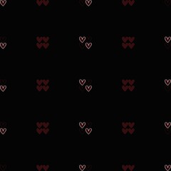 Pattern of hearts in varying sizes on a dark background, creating a romantic design