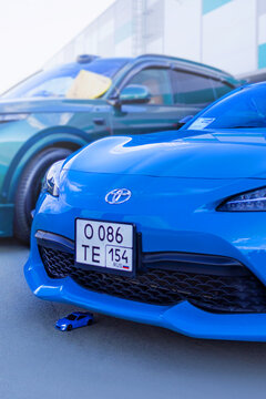 15.09.2024. Novosibirsk, Midday, Blue Toyota GT86 and little toy car