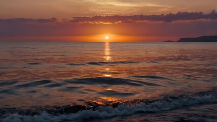 Obraz premium Sunset over the sea, featuring a beautiful orange, red, and purple evening sky, with ocean water gently rippling, creating a stunning wallpaper background
