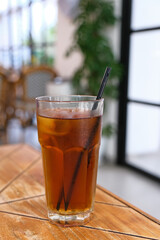 A glass of  iced tea on the table

