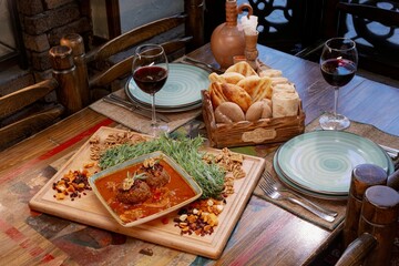 Rustic table with traditional meal and wine.