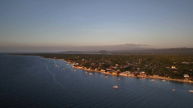 Anchored Boats At The Coastal Town Of Moalboal In The Province of Cebu, Philippines. Aerial Drone Shot
