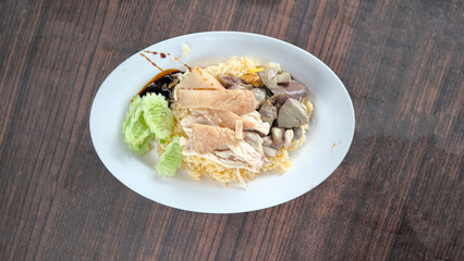 Chicken rice in a white plate on the dining table