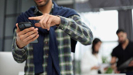 Close-up of male hands using a mobile phone or smartphone.