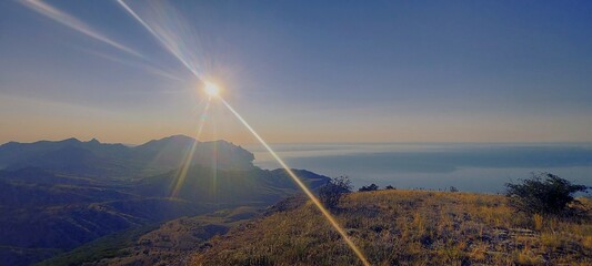 Majestic summer sunrise viewed from mountaintop. Amethyst color. Beautiful glare from the sun....