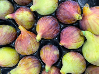 Group of figs on black background. Healthy food. Figs close-up as background in Greek market....