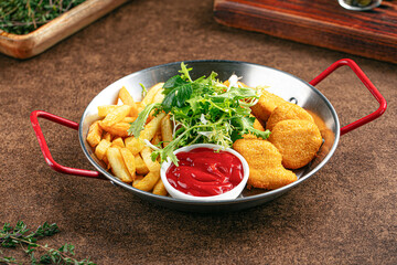 Pan of deep fried appetizers with ketchup