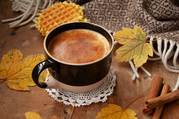 Cozy autumn coffee with leaves and a blanket
