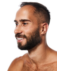 Obraz premium Close-up portrait of handsome young bearded man with tanned, spotless, clear skin, smiling, posing isolated on white studio background. Concept of male beauty, skin care, hygiene, health