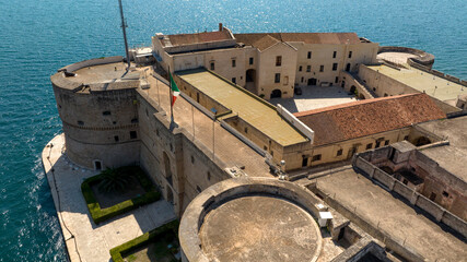 Aerial view of the Aragonese castle, officially called Castel San Angelo, in the historic center of Taranto, Puglia, Italy. It has a quadrangular plan and a large central courtyard.