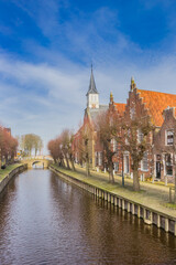 Fototapeta premium Canal leading to a small bridge in the historic city Sloten, Netherlands