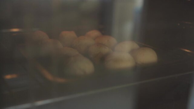 Close up view of chipa bread baking in a home oven, showcasing the traditional process of preparing this hallowed, typical basket bread from riverside argentinean provinces