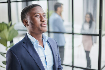 Head shot close up young thoughtful african american businessman entrepreneur looking away.