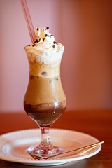 Iced coffee with whipped cream and chocolate shavings.