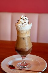 Iced coffee with whipped cream and chocolate shavings