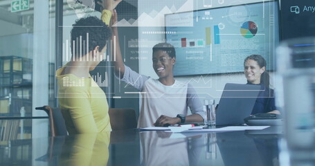 Image of financial data processing over diverse business people in office