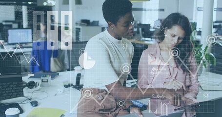 Image of financial data processing over diverse businesswomen in office