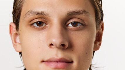 Obraz premium Closeup, detailed photo of face of young man looking at camera against white studio background. Appearance and uniqueness. Concept of natural beauty, fashion, cosmetic product, male health. Ad