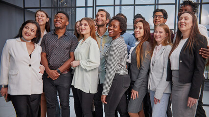 smiling young multiracial workers staff group pose together as human resource