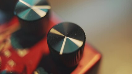 Turning a volume knob on a guitar effect pedal
