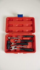 A set of tools in a red case on a table.
