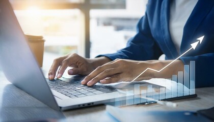 Male Hands on keyboard notebook in a corporate environment with bar and line graphics on the screen and background with deep of field.