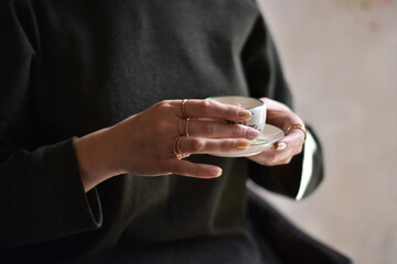Close up Woman hands holding cup of delicious coffee . 