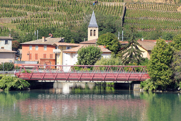 small bridge and village on river Rhone in France