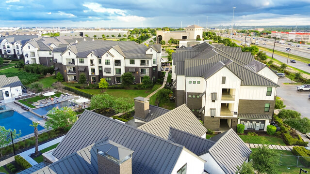 Swimming pool spa in new development apartment complex with metal roofing, siding near Interstate Highway I-35, fast growing area Pflugerville northeast of downtown Austin, Texas, housing market