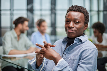 smiling African American business man with executives working in background