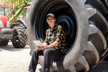 Agricultural or Construction equipment dealer or service centre. Female worker with digital tablet...