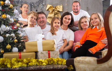 Big family is celebrating New Year together and talking at table indoors