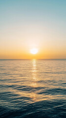 Tranquil ocean sunset with golden reflections on calm water, perfect for nature and relaxation themes