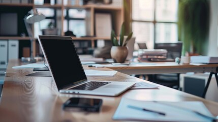 Fototapeta premium A spacious, modern office with a sleek laptop on a pristine desk, surrounded by well-organized paperwork and a contemplative ambiance enhancing productivity.