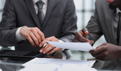 Close-up of business people in smart discussing something while