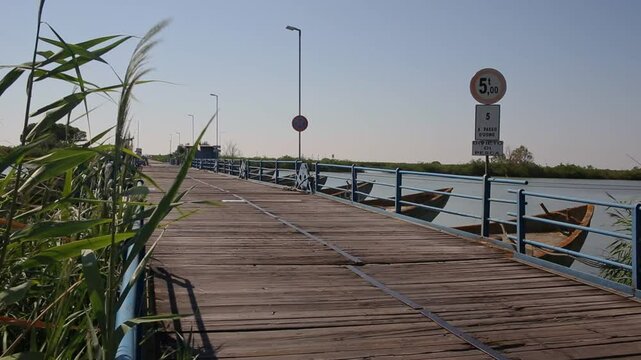 Unique boat bridge car pass constructed on Po di Goro river delta, rural Italy