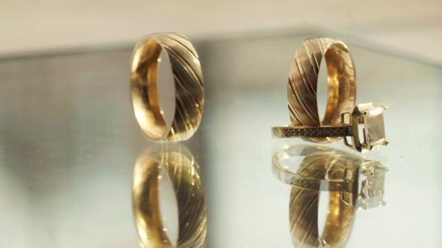 Detailed close-up of 14k yellow gold wedding bands featuring a double-line design