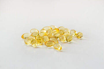 Cod liver oil vitamin e soft gel capsules on white background