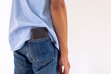 Man put wallet in back pocket of his trousers. Beware of pickpockets concept.