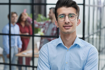 Portrait of successful businessman standing in office