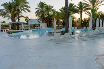Relaxing pool surrounded by greenery and a beautiful sunset.