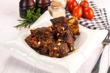 Prepared tasty beef ribs with sauce