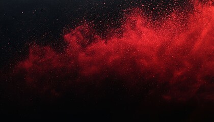A vibrant red powder explosion against a dark background, creating an abstract and dramatic visual effect.